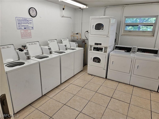 laundry area featuring independent washer and dryer, stacked washing maching and dryer, and light tile patterned floors