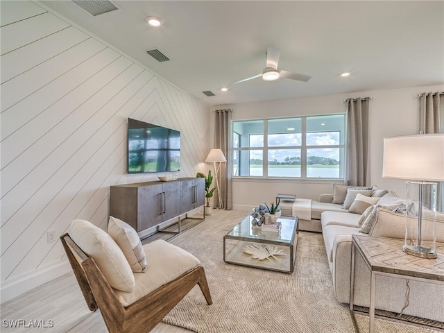 living room with wooden walls and ceiling fan