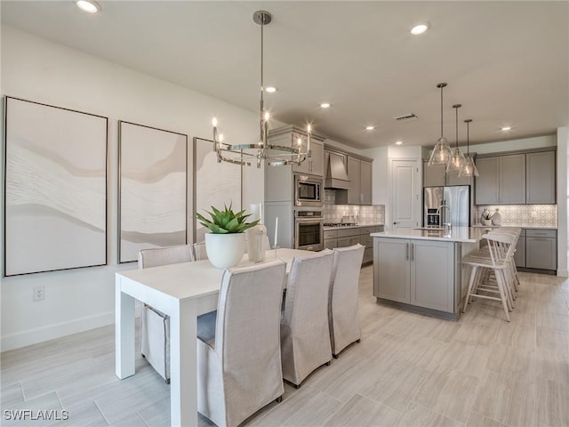 dining space featuring sink and a chandelier