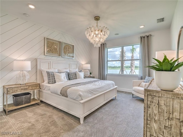 bedroom featuring a chandelier, carpet flooring, and wooden walls