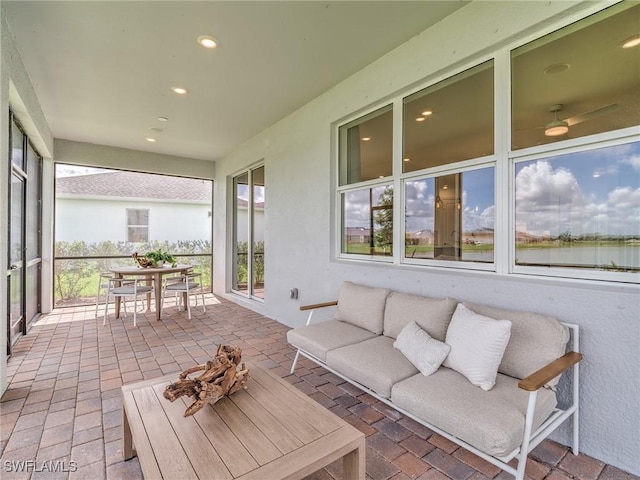 sunroom / solarium featuring a water view