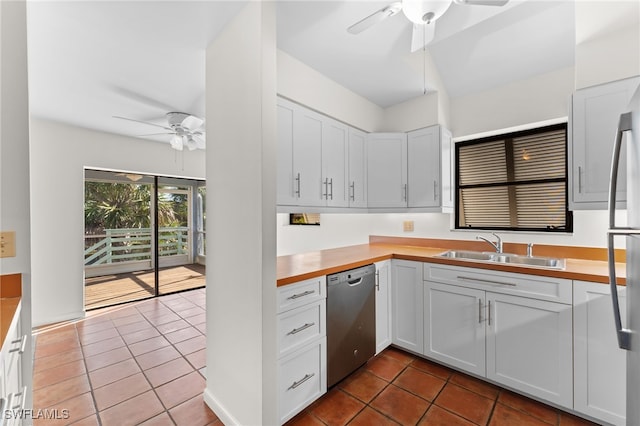 kitchen featuring white cabinetry, dishwasher, sink, light tile patterned floors, and ceiling fan