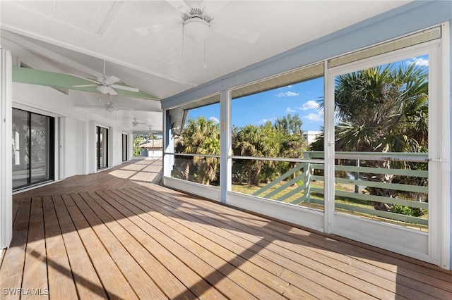 unfurnished sunroom featuring vaulted ceiling and ceiling fan