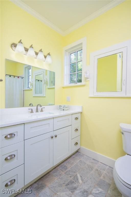 bathroom with toilet, vanity, crown molding, and curtained shower