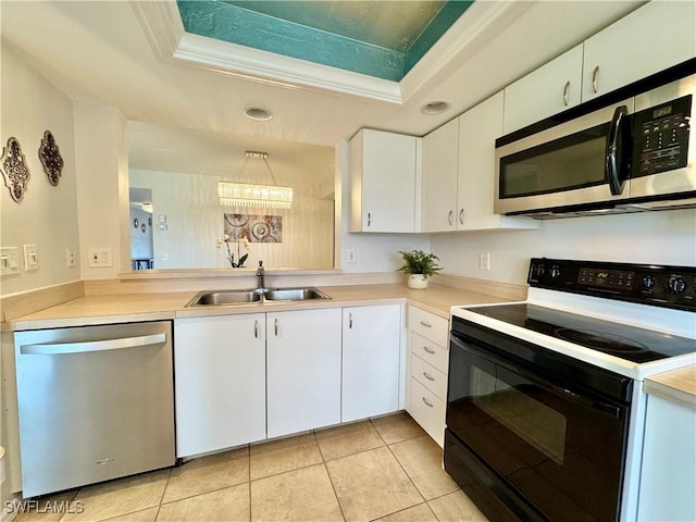 kitchen featuring sink, stainless steel appliances, a raised ceiling, and white cabinets