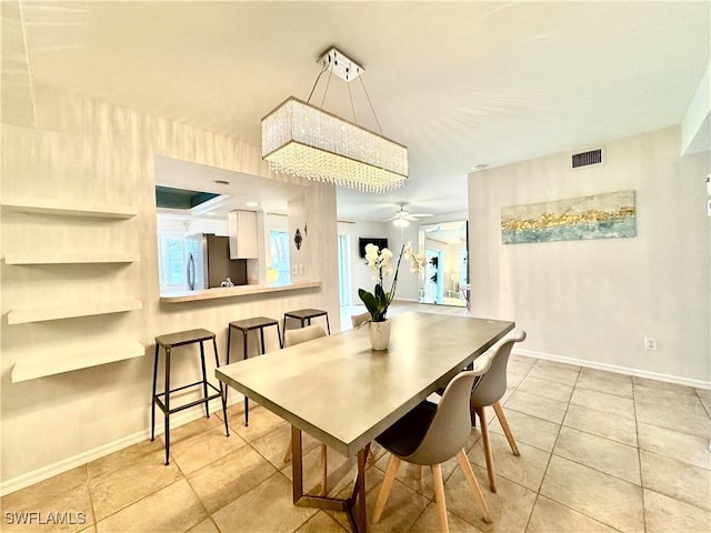 tiled dining area featuring ceiling fan