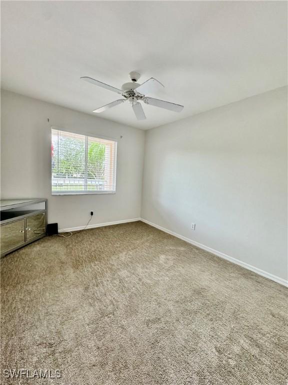 carpeted empty room with ceiling fan