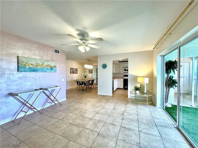 interior space featuring light tile patterned floors and ceiling fan