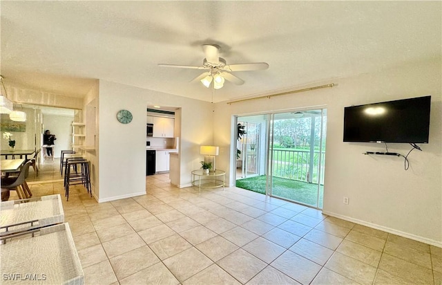 unfurnished living room with light tile patterned flooring and ceiling fan