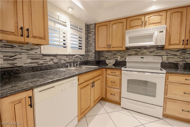 2121 Collier Ave Unit 406, Fort Myers, FL 33901 - kitchen featuring white appliances, dark stone counters, tasteful backsplash, sink, and light tile patterned floors