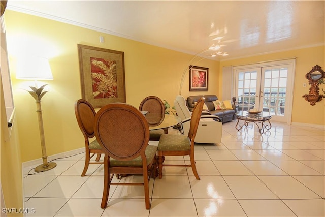 dining room featuring french doors, crown molding, and light tile patterned floors