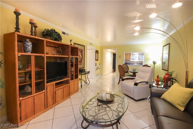 living room with ornamental molding and light tile patterned floors