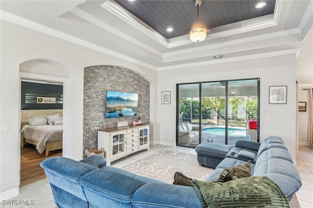 living room featuring light tile patterned floors, wood ceiling, ornamental molding, and a raised ceiling