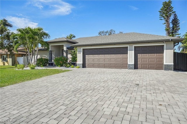 view of front of property with a garage and a front yard