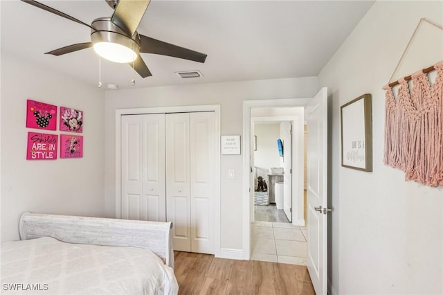 bedroom with light hardwood / wood-style floors, a closet, and ceiling fan