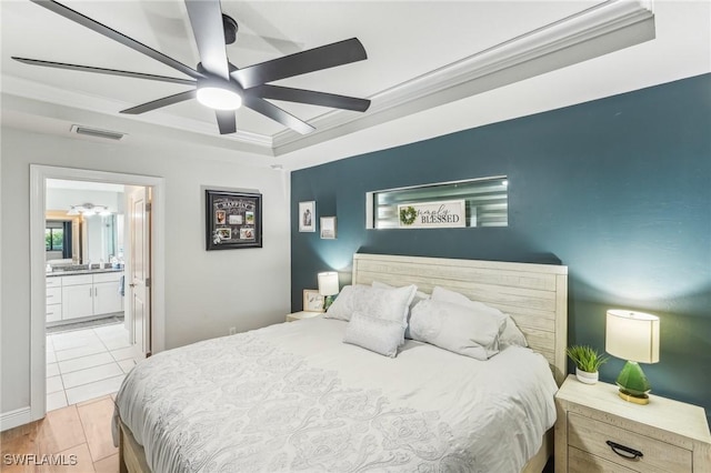 bedroom featuring ceiling fan, ornamental molding, connected bathroom, and a raised ceiling