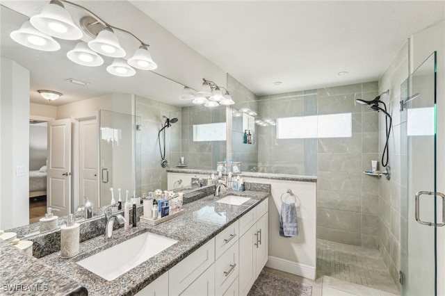 bathroom with tile patterned flooring, vanity, and an enclosed shower