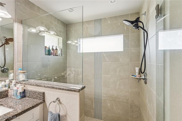 bathroom featuring vanity and tiled shower