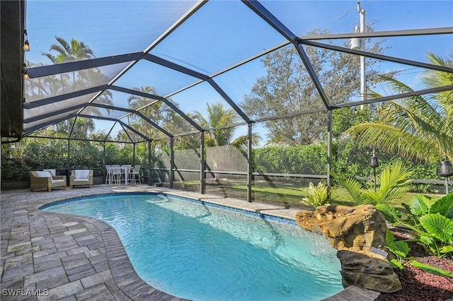 view of pool featuring a lanai, outdoor lounge area, and a patio