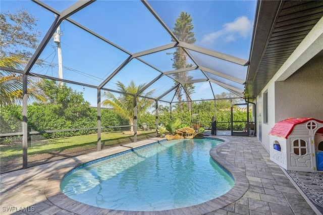 view of swimming pool featuring a lanai and a patio area