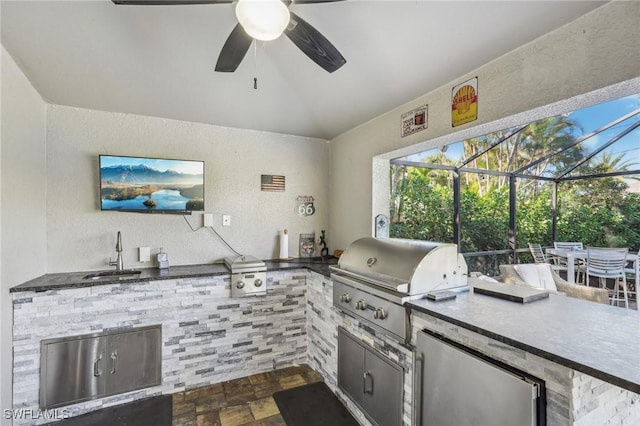 view of patio / terrace featuring area for grilling, sink, a lanai, and an outdoor kitchen