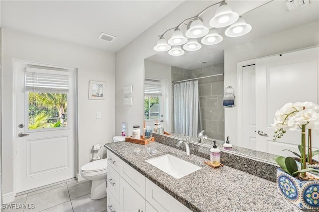 bathroom with vanity, tile patterned flooring, a shower with curtain, and toilet