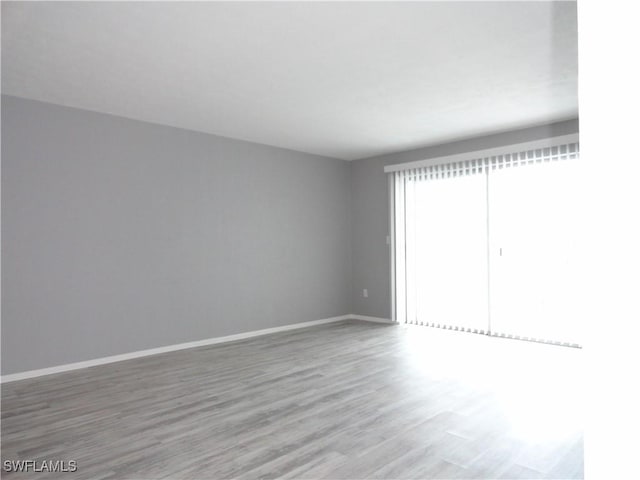 unfurnished room featuring hardwood / wood-style floors