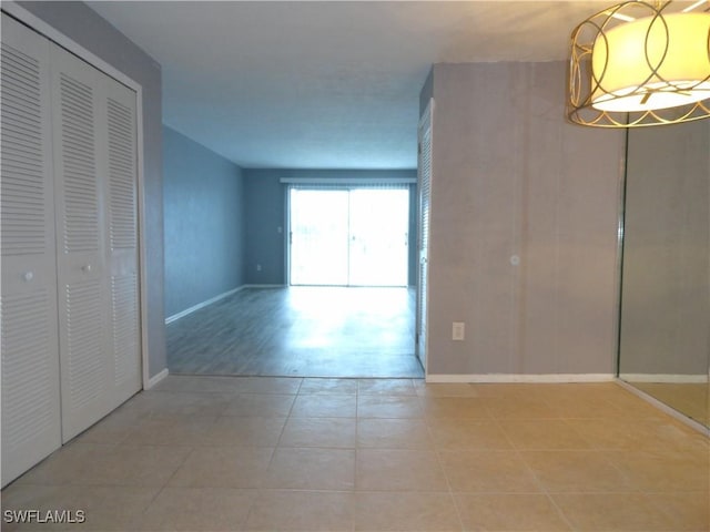 interior space with a closet and light tile patterned floors