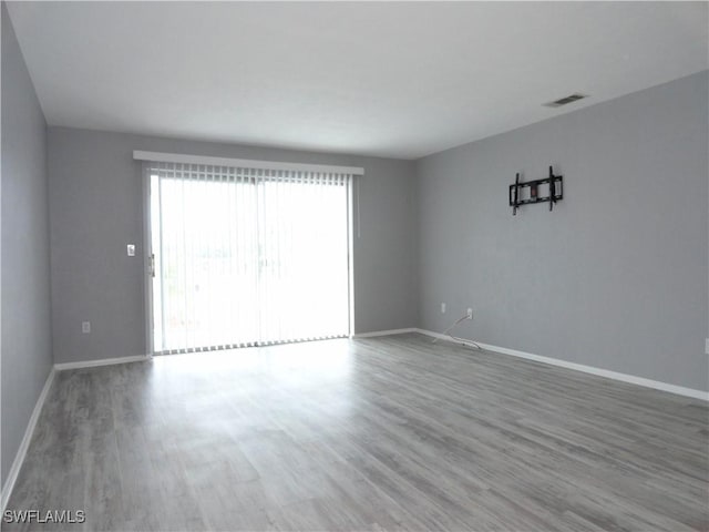 spare room with hardwood / wood-style flooring