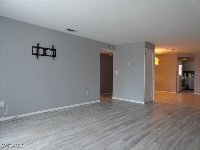 unfurnished room with light hardwood / wood-style flooring