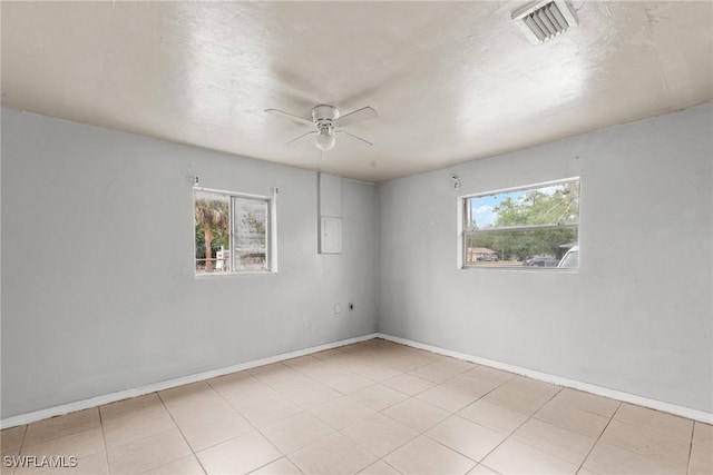 6135 Markland Ave, Fort Myers, FL 33916 - empty room with ceiling fan, baseboards, visible vents, and a wealth of natural light