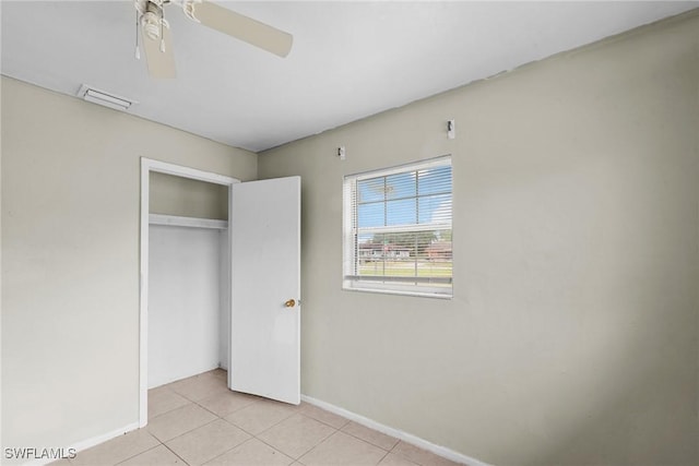 6135 Markland Ave, Fort Myers, FL 33916 - unfurnished bedroom featuring a closet, baseboards, light tile patterned floors, visible vents, and ceiling fan
