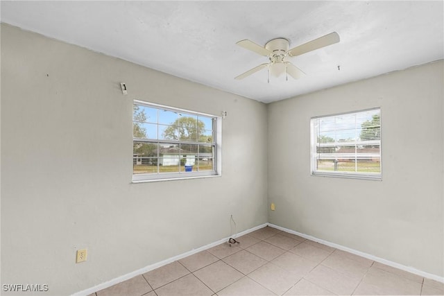 6135 Markland Ave, Fort Myers, FL 33916 - spare room featuring baseboards, light tile patterned flooring, and ceiling fan