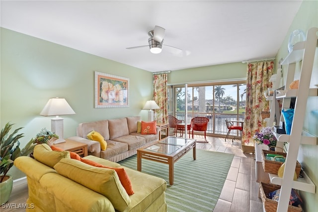 living room featuring a water view and ceiling fan