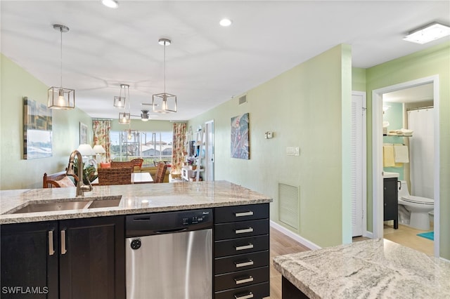 kitchen with sink, light hardwood / wood-style flooring, dishwasher, light stone countertops, and decorative light fixtures