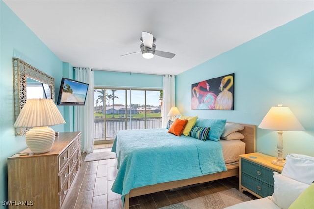 bedroom featuring multiple windows, access to exterior, and ceiling fan