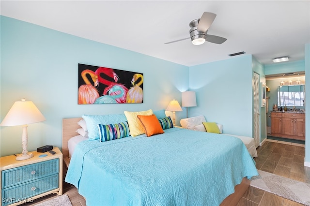 bedroom featuring a closet, ceiling fan, and ensuite bath