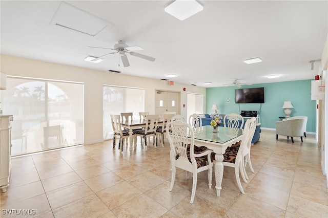 tiled dining space with ceiling fan