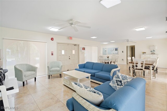 living room featuring light tile patterned floors and ceiling fan