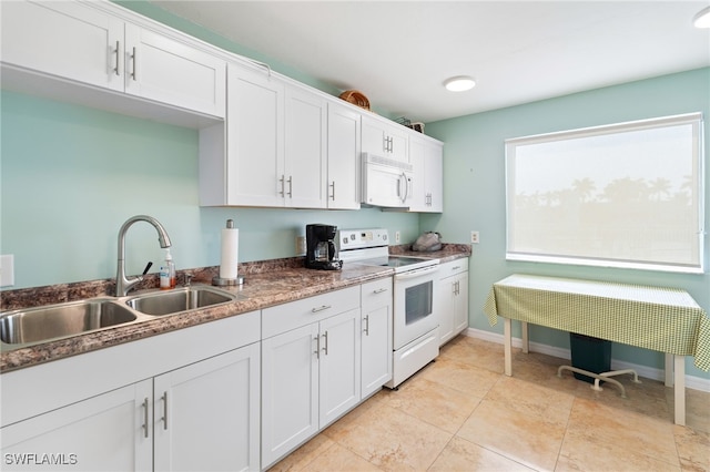 kitchen with sink, white cabinets, and white appliances