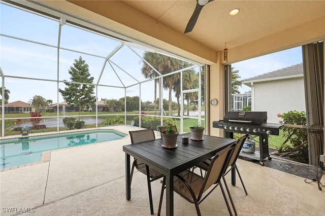 view of pool featuring a patio area, a lanai, a water view, and grilling area