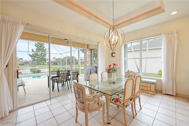 dining space with an inviting chandelier, light tile patterned floors, and a raised ceiling