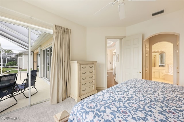 carpeted bedroom with ceiling fan and ensuite bathroom