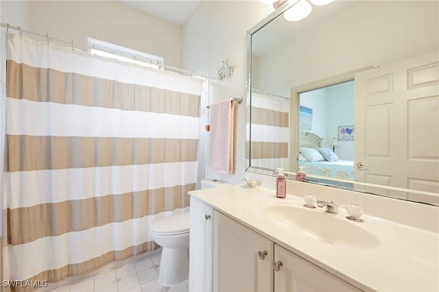 bathroom featuring toilet, vanity, and tile patterned flooring