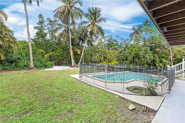 view of swimming pool with a lawn