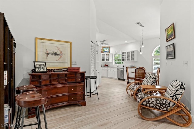 sitting room with ceiling fan and lofted ceiling