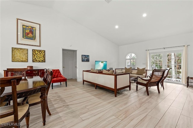 living room featuring french doors and high vaulted ceiling