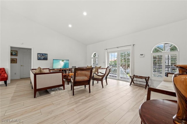 living room with high vaulted ceiling and french doors