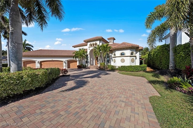 mediterranean / spanish-style house with a garage