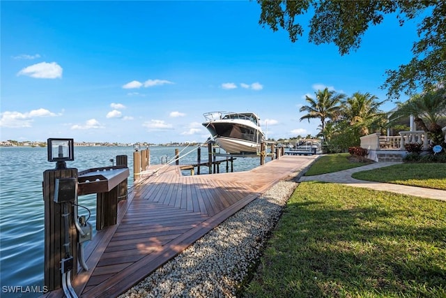 dock area with a yard and a water view